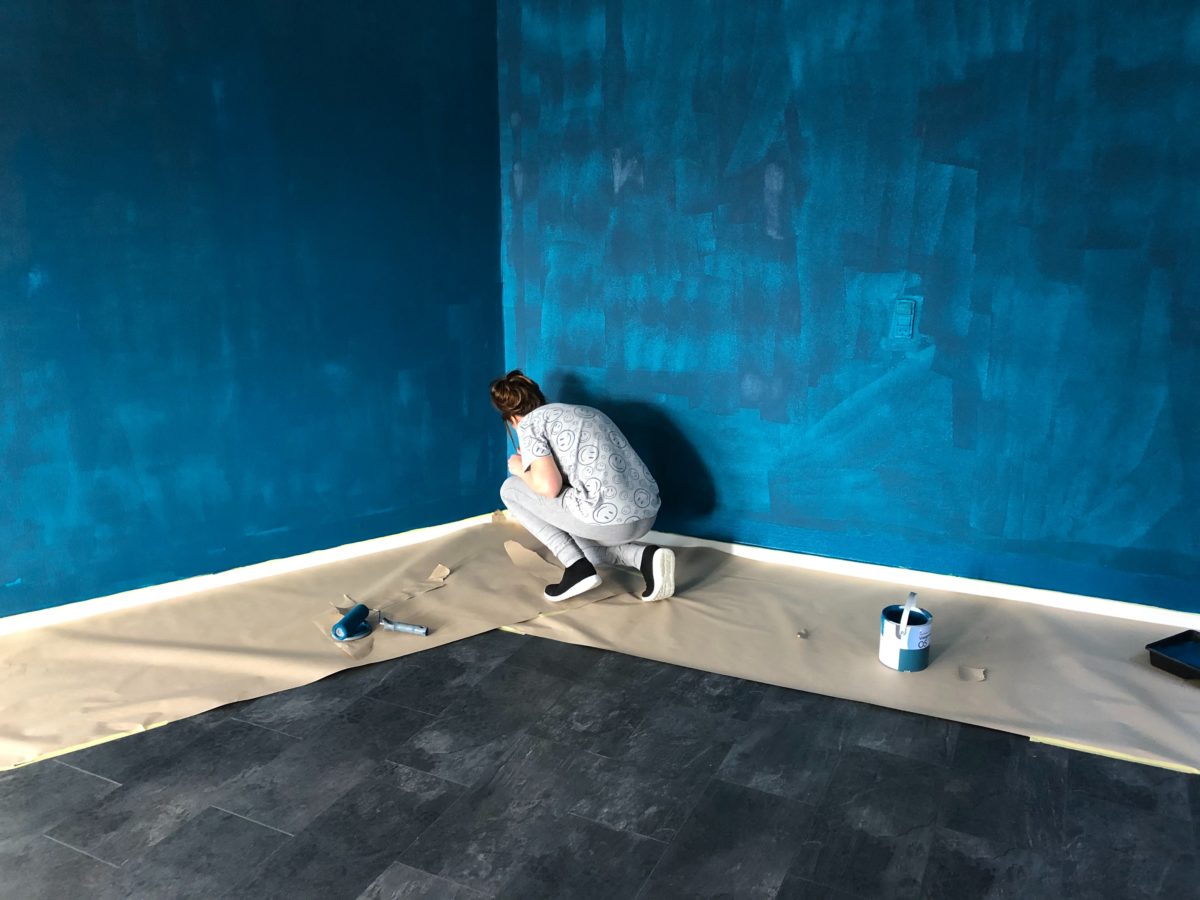 man painting the walls